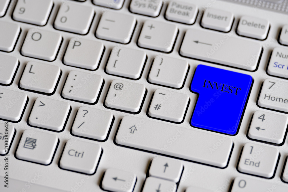 Computer keyboard showing the word invest. Computer keyboard showing the word invest.