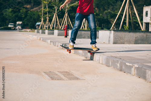Skateboarder riding skateboard going down the step