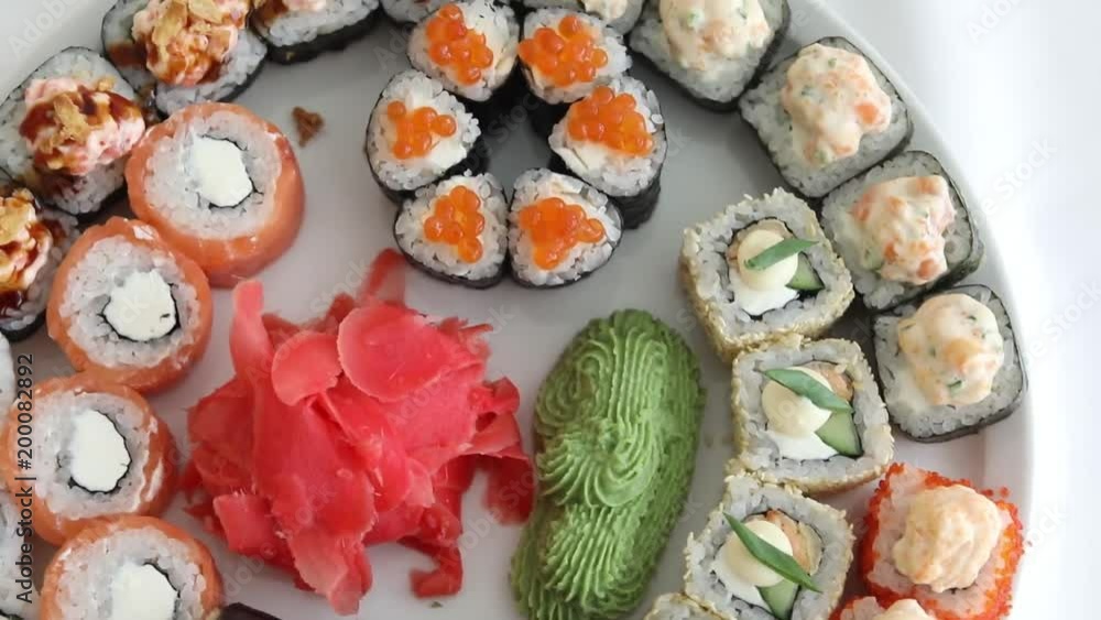 Sushi roll set on white plate background. Sushi japanese food in restaurant. Japan restaurant menu top view Sushi roll set on white plate background. Sushi japanese food in restaurant. Japan restaurant menu top view
