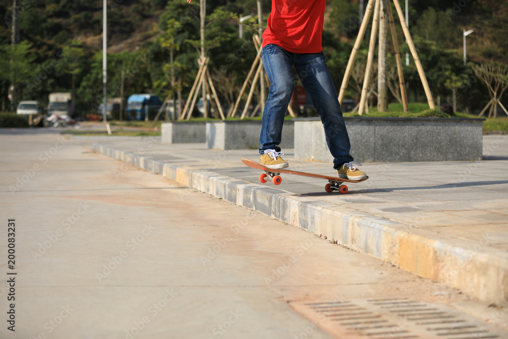 Skateboarder riding skateboard going down the step Skateboarder riding skateboard going down the step