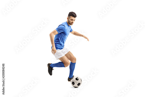 Obraz na plátně Soccer player dribbling