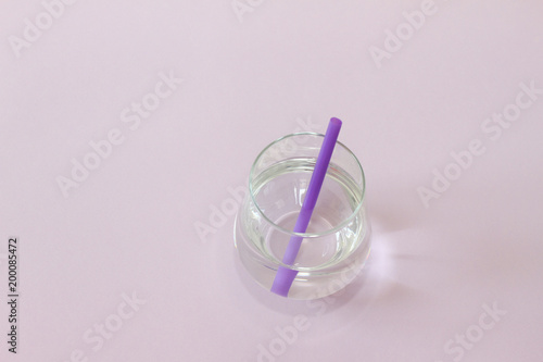 Glass of water. Glass of pure water on purple background. Detox and healthy food concept. Boost your metabolism concept. 
