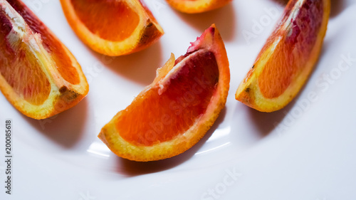 pieces of blood orange on white plate