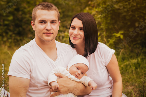 Young parents and a newborn baby together, and nature   © Olya Komarova