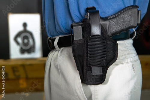 Man wearing a handgun in a webbing holster