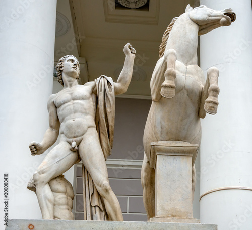 RUSSIA, SAINT PETERSBURG - AUGUST 18, 2017: Statue of naked boy with horse (Dioscuri). Saint Petersburg Manege (Konnogravdeysky arena). One of the symbols of St. Petersburg photo