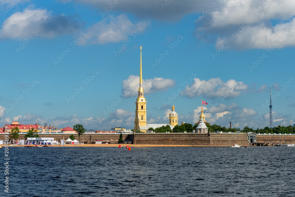 RUSSIA, SAINT PETERSBURG - AUGUST 18, 2017: View on the Peter and Paul Fortress, the river Neva, the steeple with a cross, dome, sky, warm summer day, storm sky