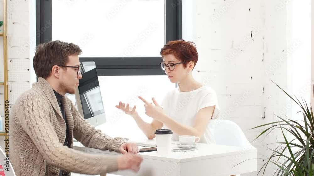Business meeting in office. Job interview: female executive is meeting candidate and talking. Business meeting in office. Job interview: female executive is meeting candidate and talking.