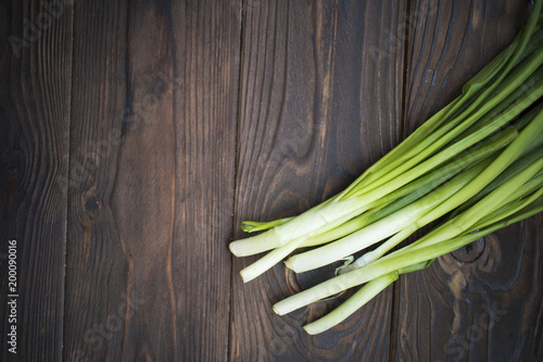 bunch of onions on wooden background. Bunch of fresh green onions