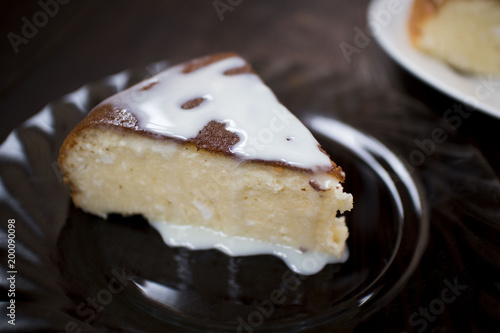 Cottage cheese cake on black plate.