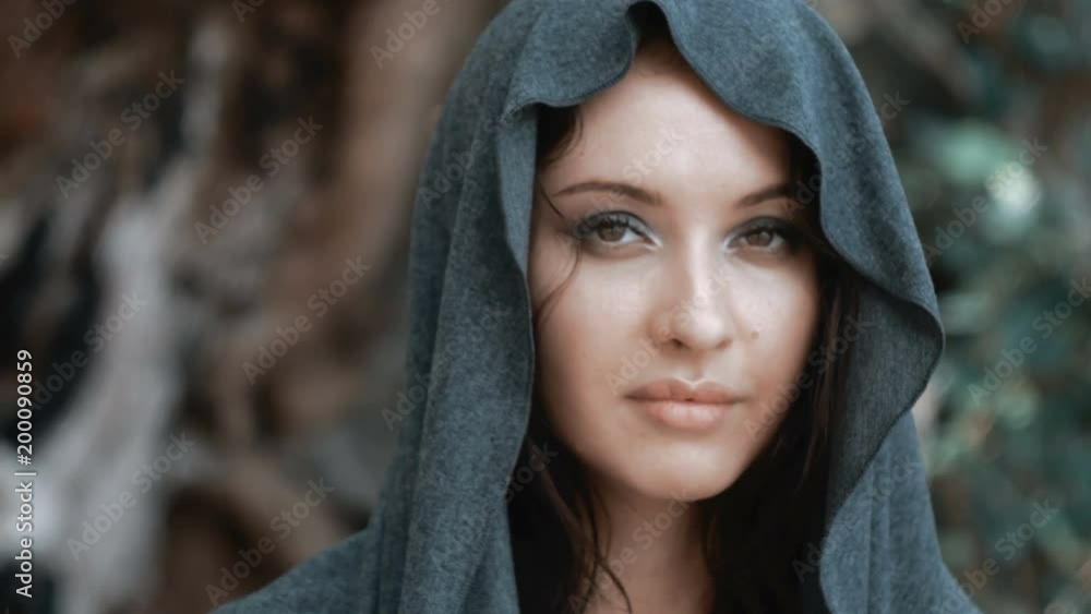 Mysterious beautiful woman with make up in grey hood Mysterious beautiful woman with make up in grey hood