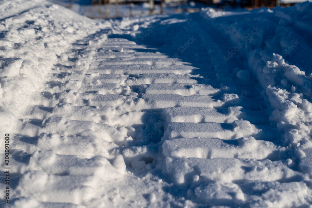 Snowmobile tracks on loose snow close-up