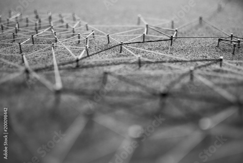 Background. Abstract concept (idea) of network, social media, internet, teamwork,  communication abstract. Nails linked together by threads. Isolated. Entities connected. photo