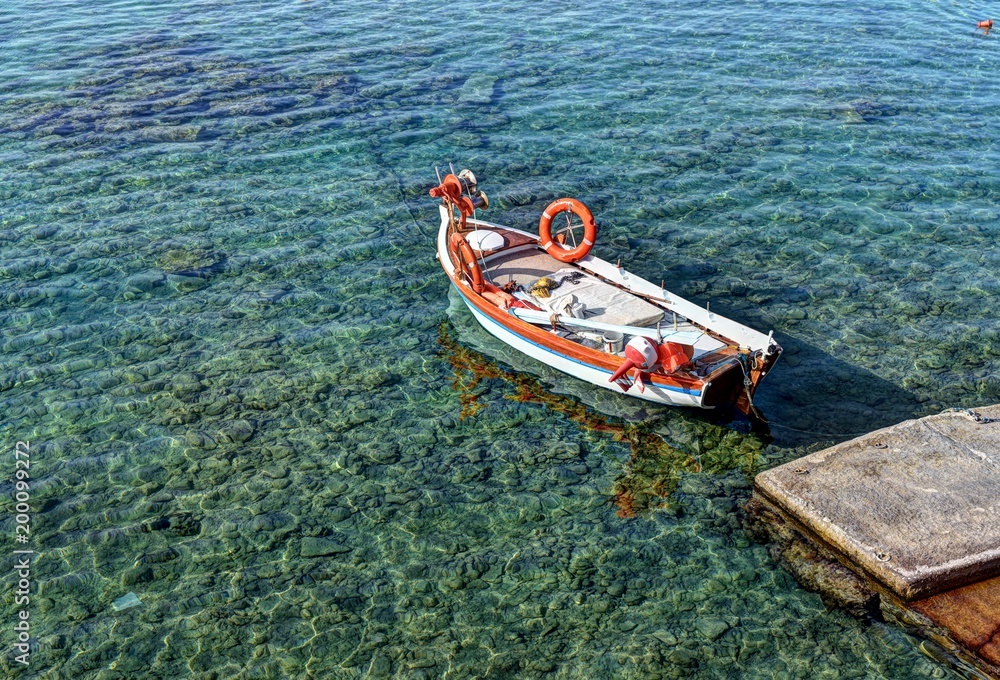 Traditional fishing boat in Mandrakia village on the coast of Milos island, Cyclades, Greece