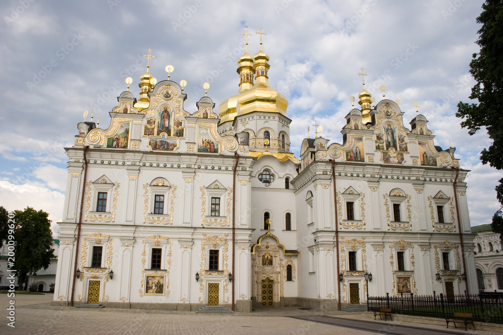 Medieval Cathedral of the Dormition on a background of sky with clouds in springtime. National Historic Cultural Sanctuary Kyiv Pechersk Lavra, Kiev, Ukraine