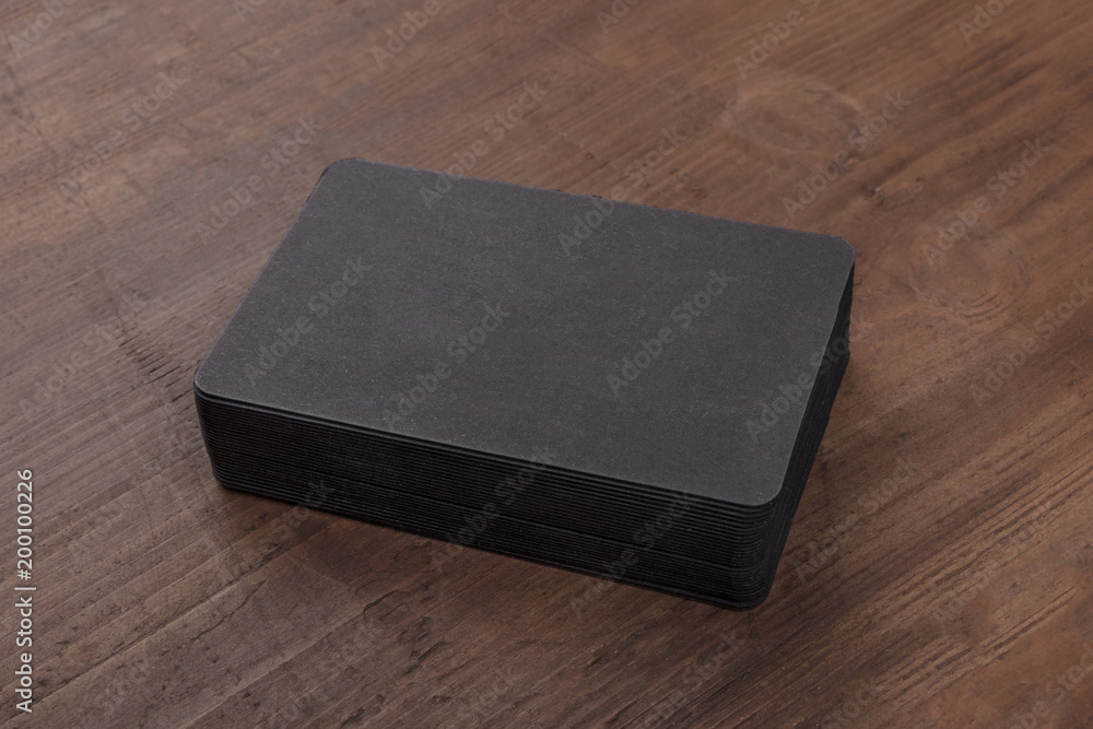 Black business cards mockup on a rustic background Black business cards mockup on a rustic background