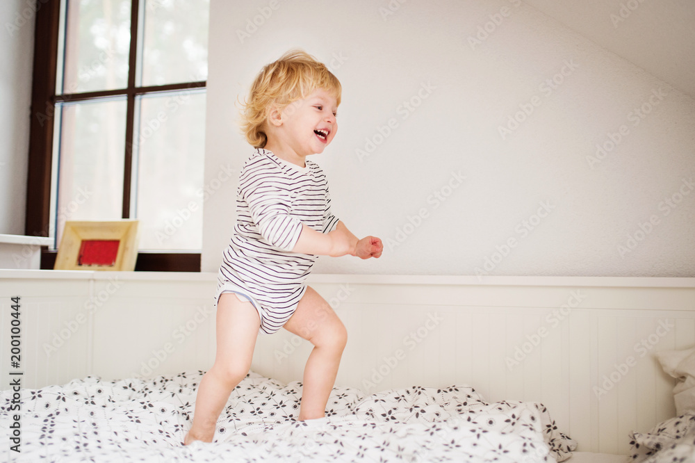 Cute toddler boy jumping on the bed. Cute toddler boy jumping on the bed.