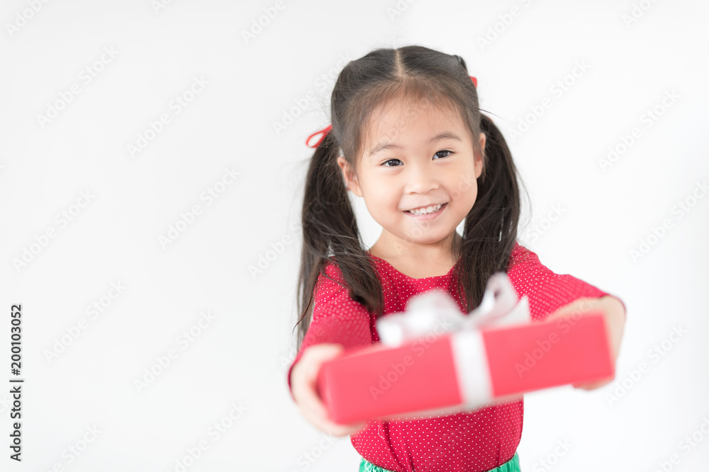 Happy asian girl in red and green colour is giveing a red gift box on White Background. Happy thanksgiving and Christmas Eve Party Concept. Happy asian girl in red and green colour is giveing a red gift box on White Background. Happy thanksgiving and Christmas Eve Party Concept.