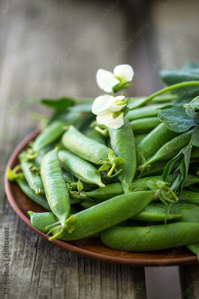 Green pea in plate on wooden background Green pea in plate on wooden background