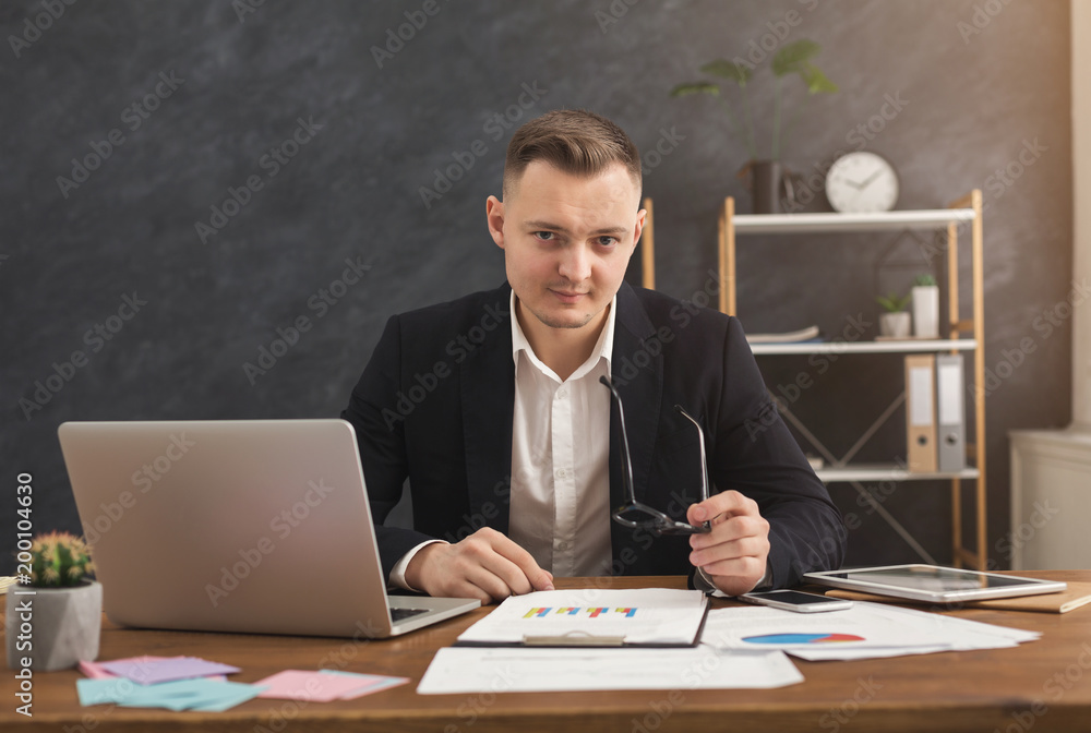 Serious man office worker is reading report Serious man office worker is reading report