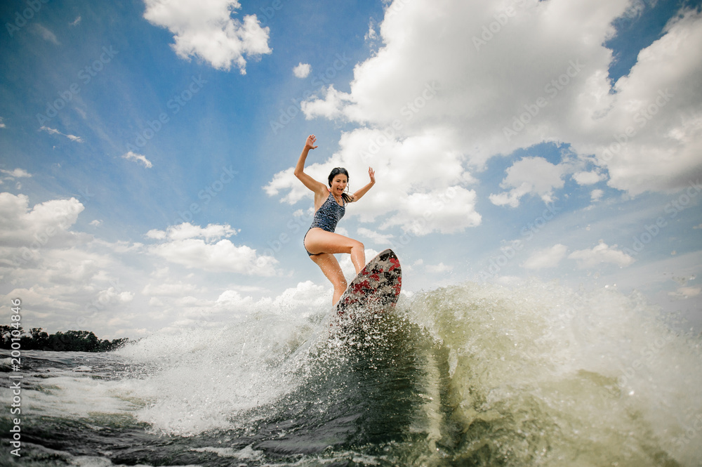 Sexy slim woman having fun wakesurfing anf jumping on the board Sexy slim woman having fun wakesurfing anf jumping on the board
