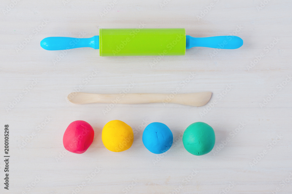 Fototapeta premium Multicolored plasticine modeling tools. Top view.