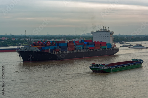 Container vessel sails down the Song Long River.
