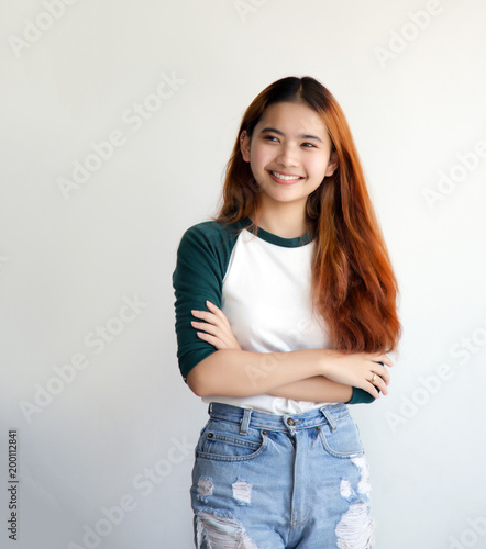 pretty asian femele smiling joyfully with colorful hair in dressed casually like hipster lifestyle,