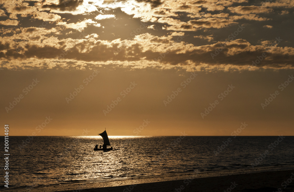 Silhouette of a boat (fishing pirogue) at the sea. Madagascar