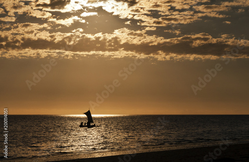 Silhouette of a boat (fishing pirogue) at the sea. Madagascar