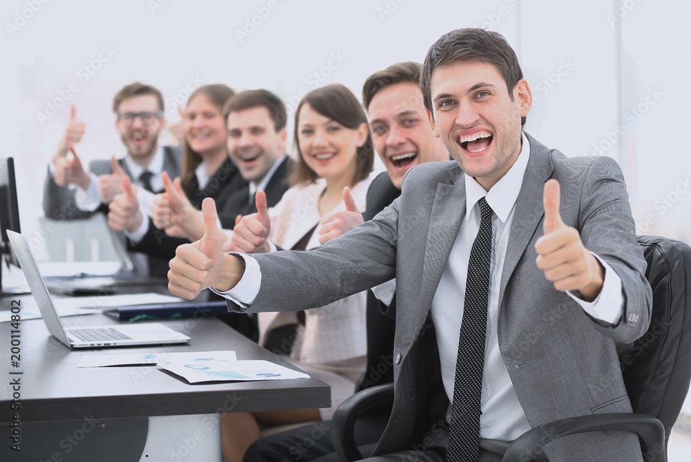 successful business team showing thumbs up successful business team showing thumbs up