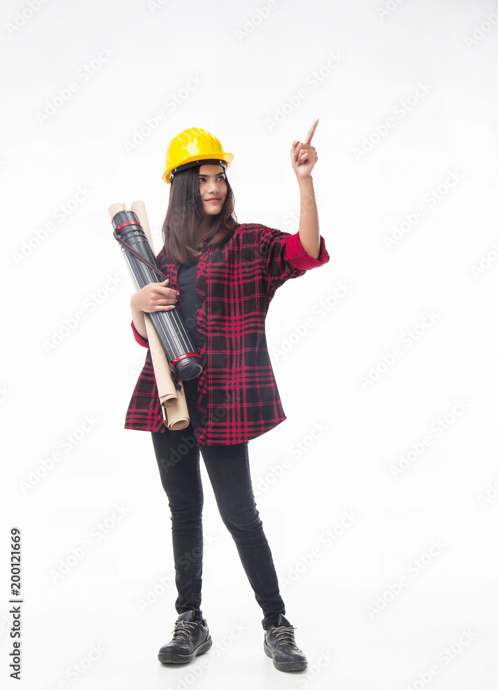 The young woman engineer with yellow safety helmet and hold blueprint in her hand.she is point finger up in the air with smile and happy face. The young woman engineer with yellow safety helmet and hold blueprint in her hand.she is point finger up in the air with smile and happy face.