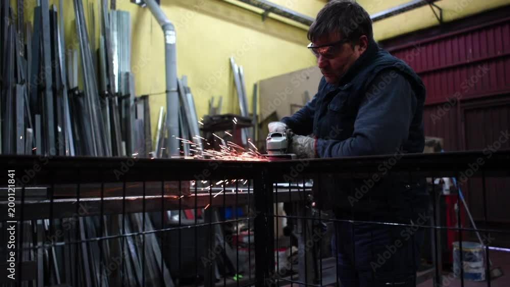 Man works with grinder cutting metal. Man works with grinder cutting metal.