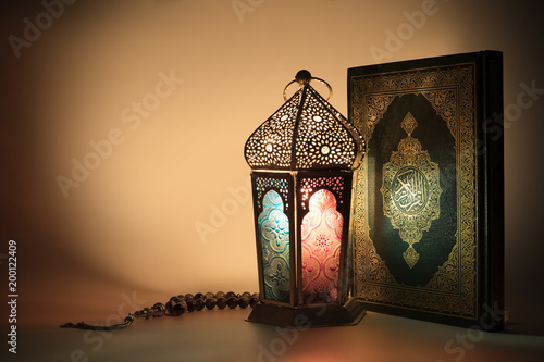 Fotografie Colored lantern with Muslims holy book Quran with special light effects
