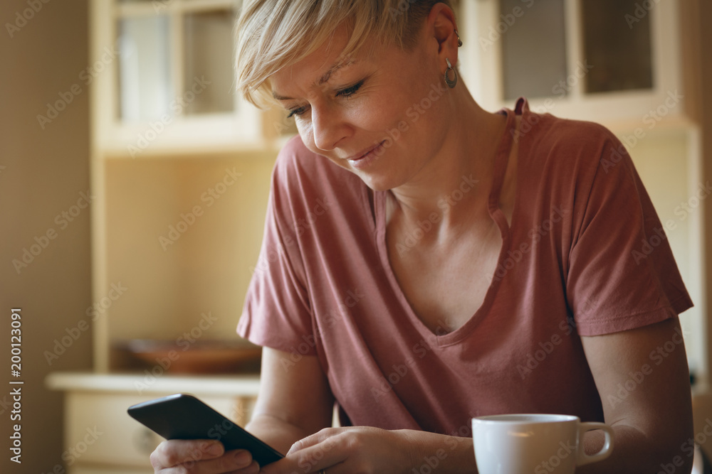 Woman using mobile phone at home Woman using mobile phone at home