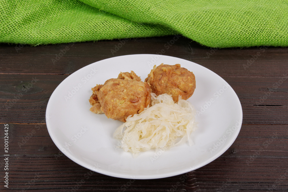 Millets potatoes dumplings with tempeh on a table Millets potatoes dumplings with tempeh on a table