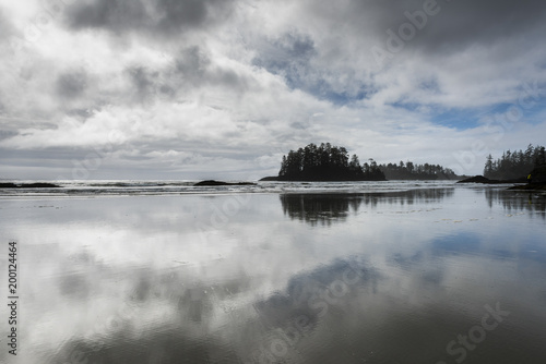 Reflection of clouds in water on beach, Pacific Rim National Park Reserve, British Columbia, Canada