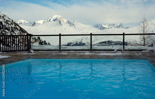 Outdoor pool and mountain slopes in the Alps in France
