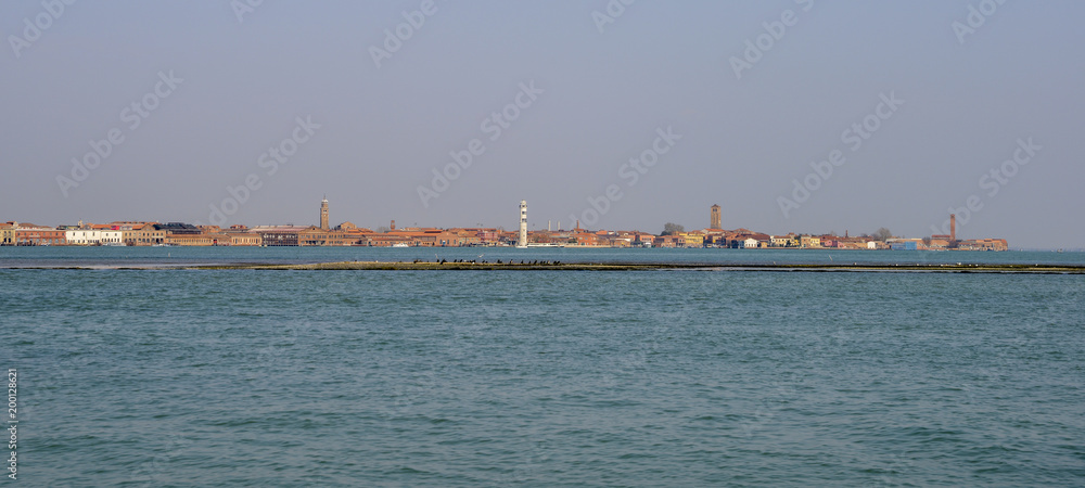 View on an old abandoned glass factory on the island of Murano from the Venice lagoon, Italy.