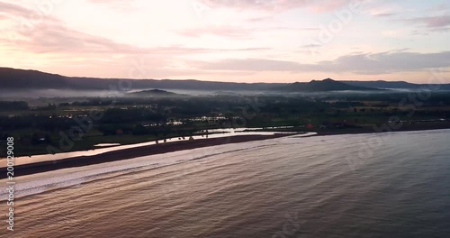 Beautiful aerial landscape of Palangpang beach on misty morning from a drone flying upward at Ciletuh Geopark, Sukabumi, West Java, Indonesia. Shot in 4k resolution photo