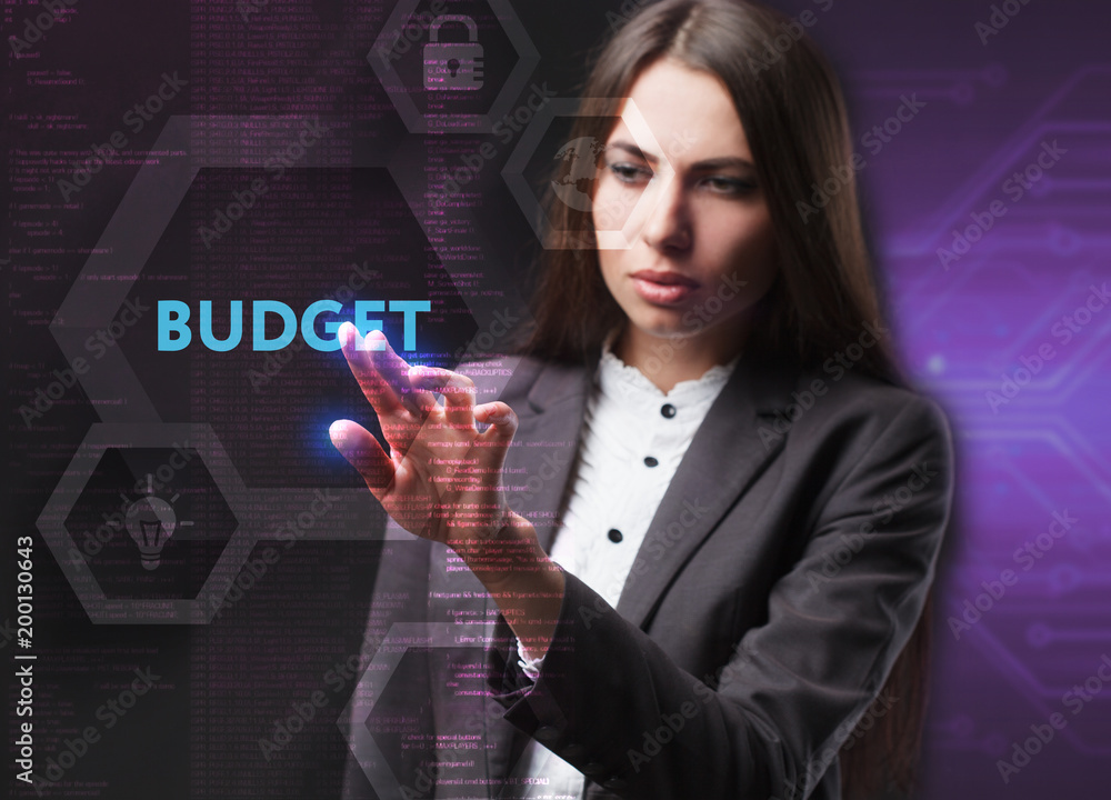 The concept of business, technology, the Internet and the network. A young entrepreneur working on a virtual screen of the future and sees the inscription: Budget The concept of business, technology, the Internet and the network. A young entrepreneur working on a virtual screen of the future and sees the inscription: Budget