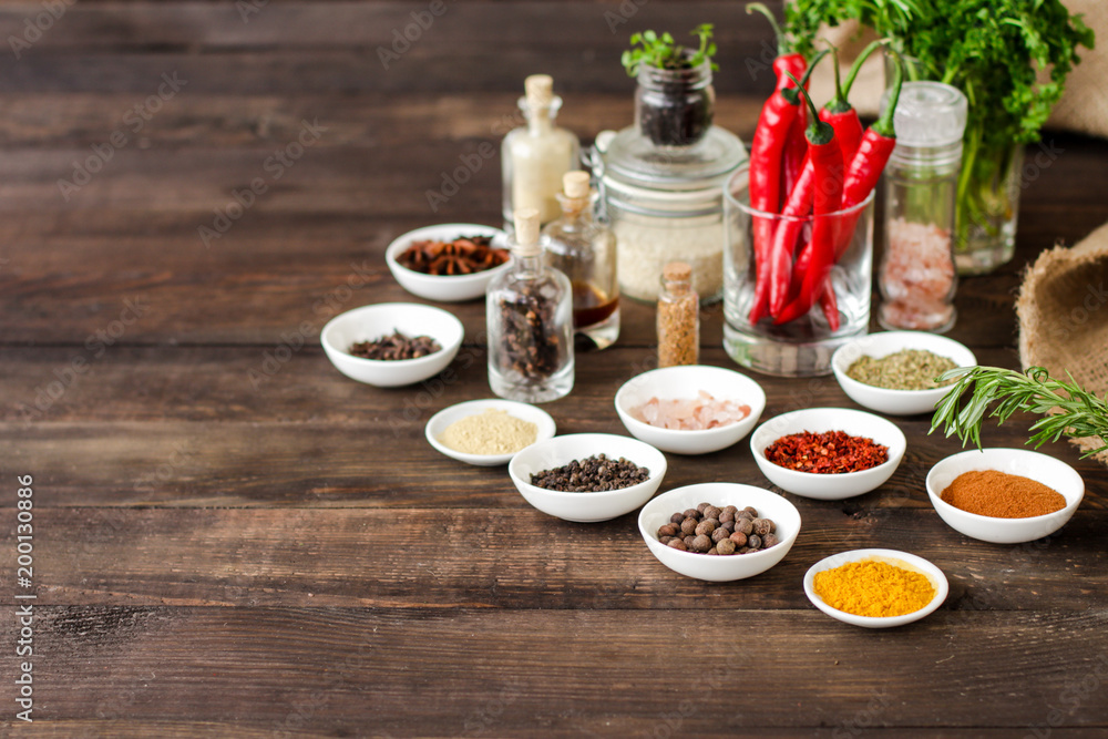 Spices and herbs. Variety of spices and herbs on a wooden surface Spices and herbs. Variety of spices and herbs on a wooden surface