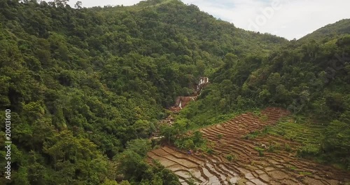 Beautiful aerial view of tropical forest and rice field near Cimarinjung waterfall at Ciletuh Geopark, Sukabumi, West Java, Indonesia. Shot in 4k resolution photo