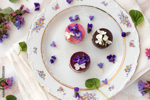 Raw vegan desserts with fresh violet and lungwort flowers
