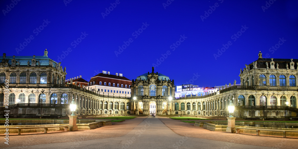 Panorama of Dresden Zwinger Palace in Rococo style at night with reflection in water bassin, Dresden, Saxony, Eastern Germany 