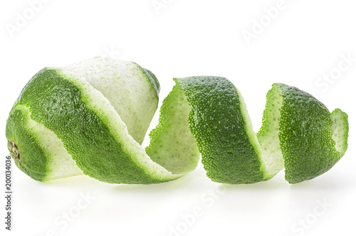 Lime fruit and its rind cut out in spiral form, white background
