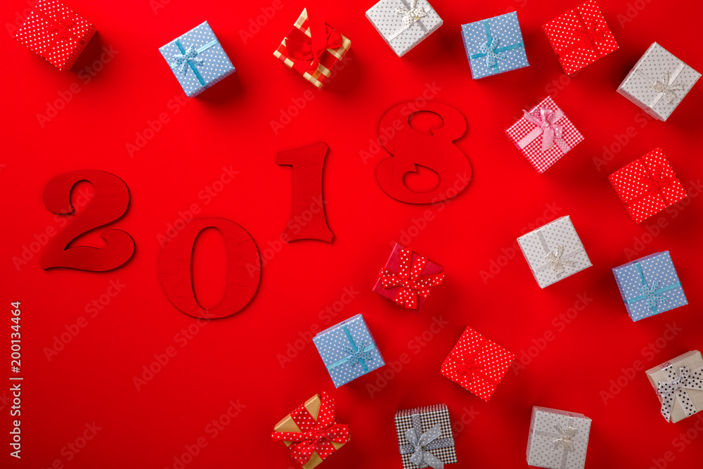 Gifts Boxes Colored on the Red Background Wooden Figures 2018 Tradition Decoration Holiday Postcard Top View Copy space for Text Flat Lay Gifts Boxes Colored on the Red Background Wooden Figures 2018 Tradition Decoration Holiday Postcard Top View Copy space for Text Flat Lay