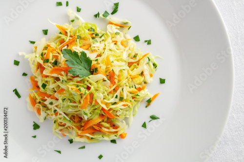 white cabbage salad with carrot and parsley