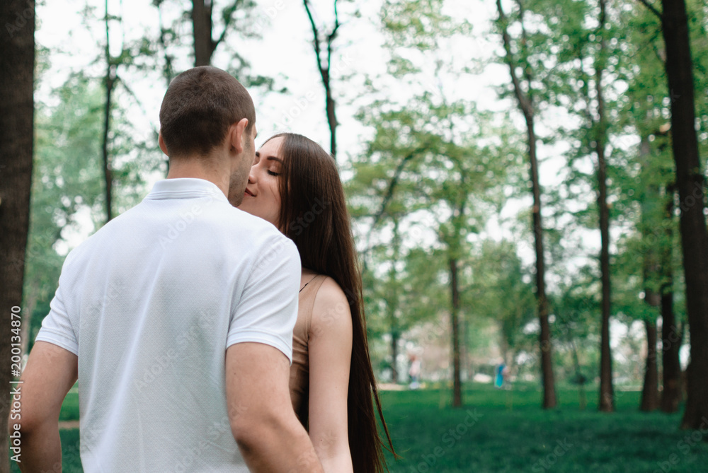 Nice outdorr portrait of young beautiful couple in love with green background Nice outdorr portrait of young beautiful couple in love with green background