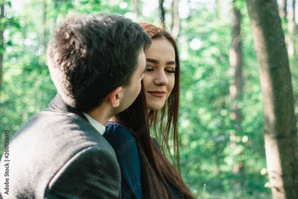 Nice outdorr portrait of young beautiful couple in love with green background Nice outdorr portrait of young beautiful couple in love with green background